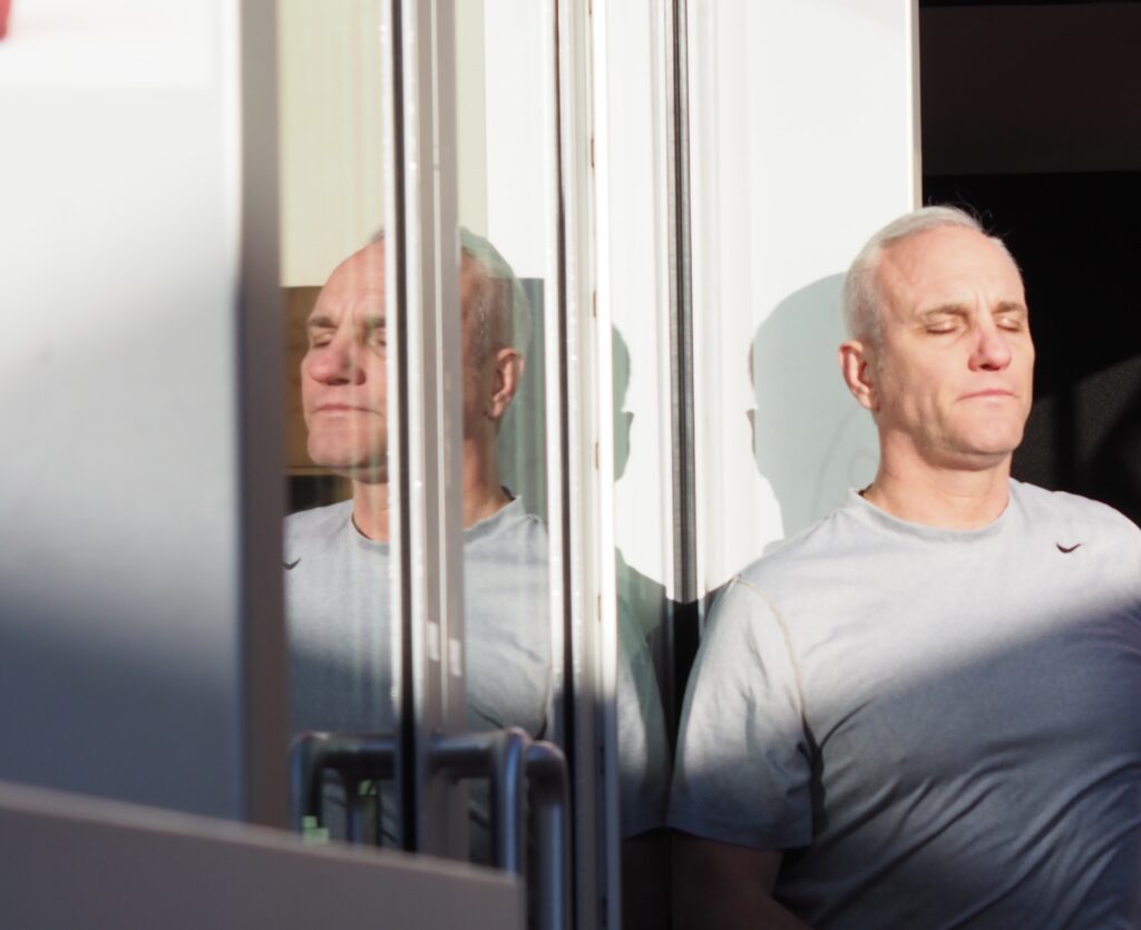 a man sits by a window