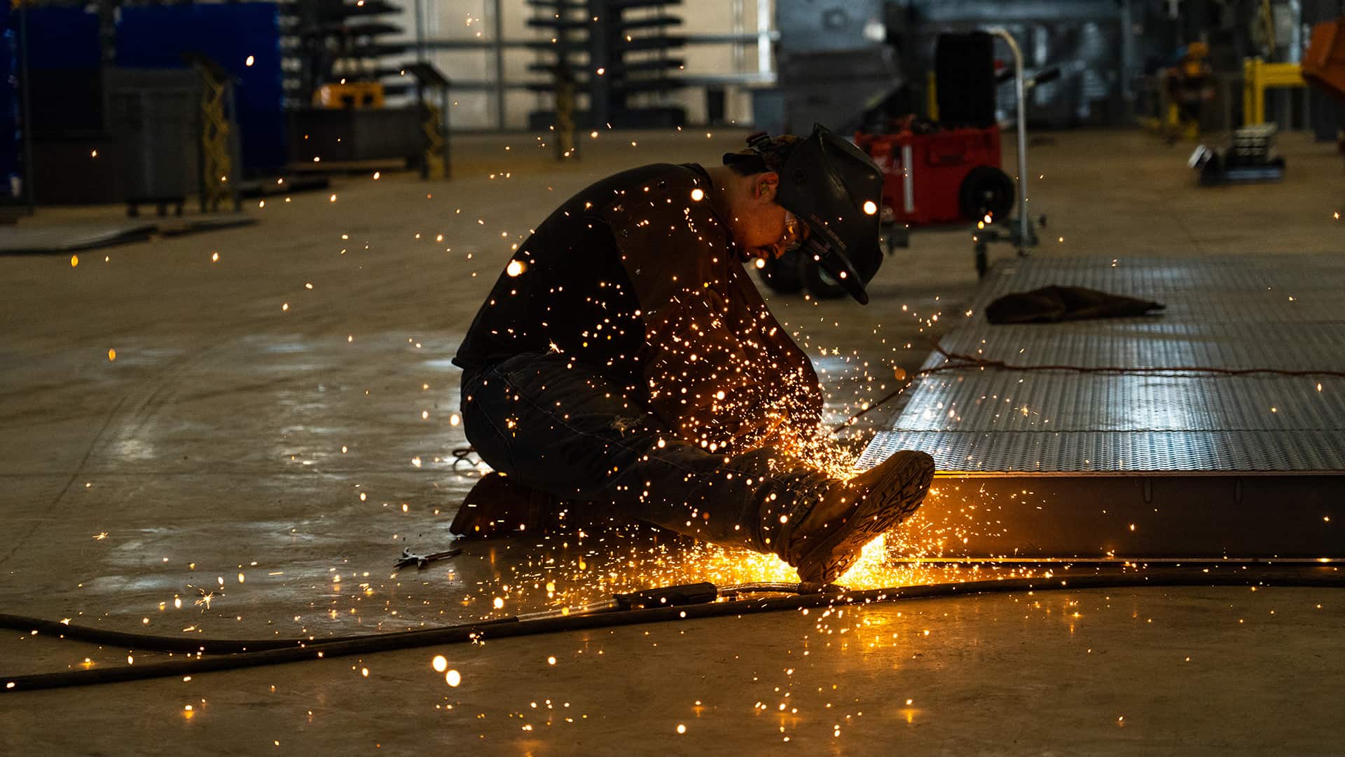 Acoustical Sheetmetal Company employee grinding metal for fuel tank